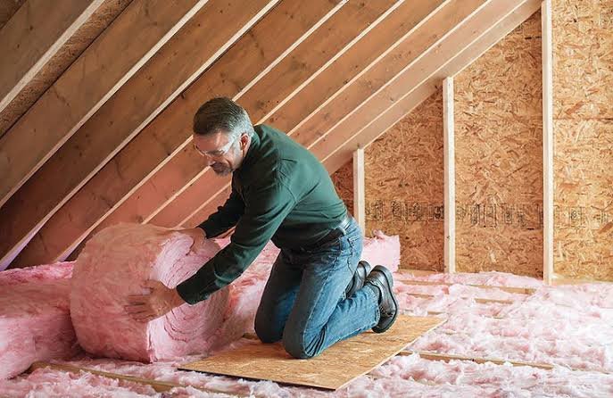 Batt insulation being laid between joists in an attic