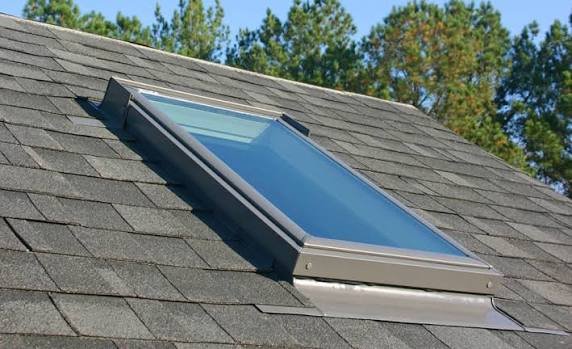 A skylight installed into an asphalt shingle roof